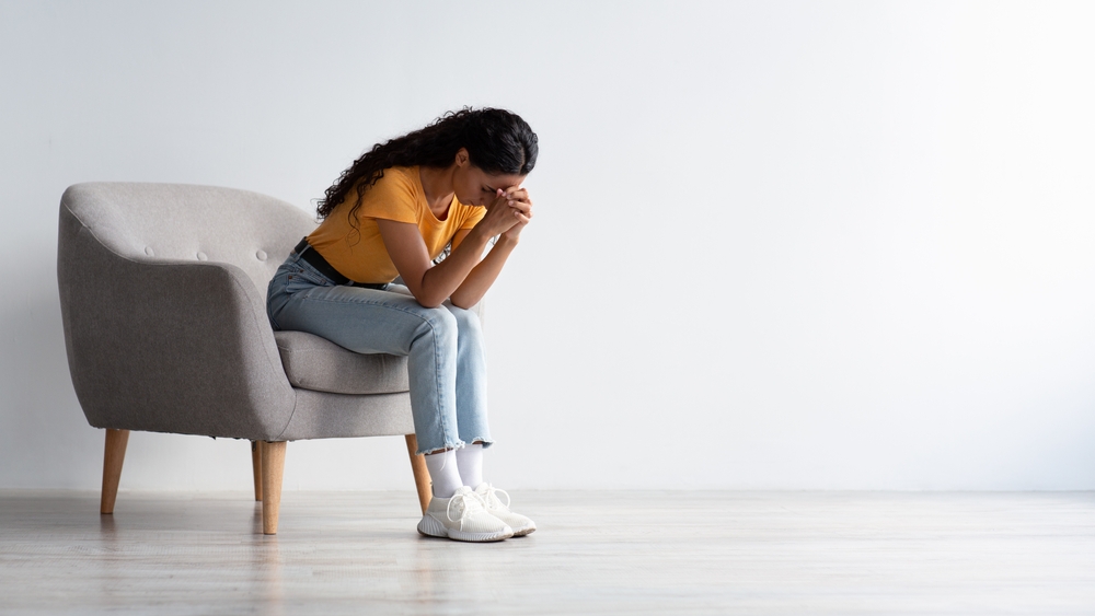 Woman sitting with head down